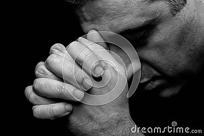 Close up of faithful mature man praying, hands folded in worship to god Stock Photo