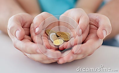 Close up of family hands holding euro money coins Stock Photo