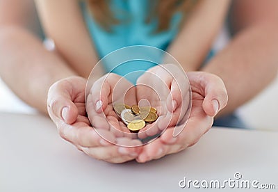 Close up of family hands holding euro money coins Stock Photo