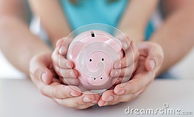 Close up of family hands with piggy bank Stock Photo