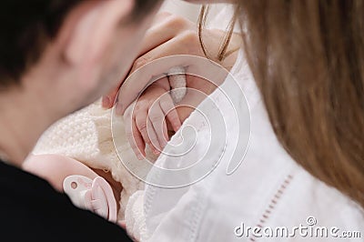 Close up family portrait of little cute baby hands in parent's h Stock Photo