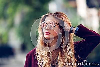 Close up fashion street stile portrait of pretty girl in fall casual outfit Beautiful blond posing outdoor. Stock Photo