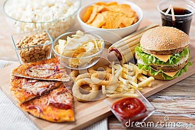 Close up of fast food snacks and drink on table Stock Photo