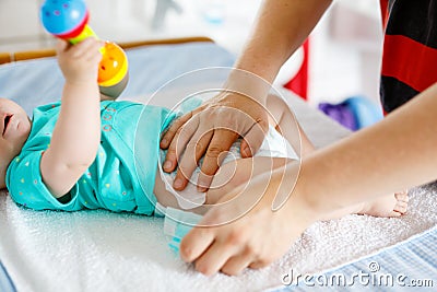 Close-up of father changing diaper of his newborn baby daughter. Stock Photo