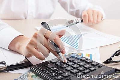 Close up of female accountant or banker making calculations. Savings, finances and economy concept Stock Photo