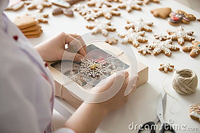 Close up of female confectioner hands wrapping a box Stock Photo