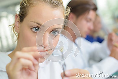 Close up female dental technician working Stock Photo