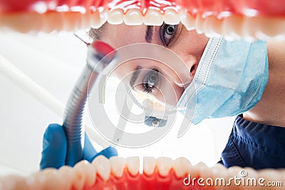 Close-up of female dentist looking inside patient mouth Stock Photo