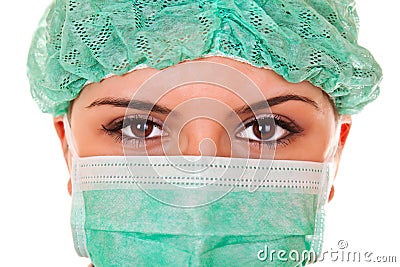 Close-up of female doctor with green mask and cap Stock Photo