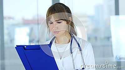 Close Up of Female Doctor Reading Medical Reports Stock Photo