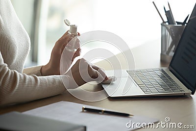 Close up of female employee disinfect workplace with sanitizer Stock Photo