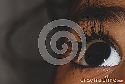 Close up of a female eye with tear drops on lashes Stock Photo