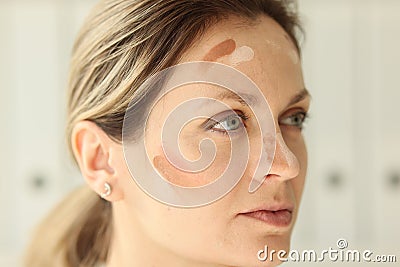 A close-up on the female face of a tonal cream smear Stock Photo
