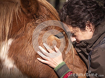 Close up of female forming bond with a piebald pony Stock Photo