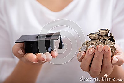 Female Holding Graduation Hat And Coins Stock Photo