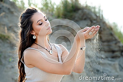 Close-up of female hand releasing dropping sand Stock Photo