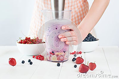 Close up of a female hands blending fruits and berries Stock Photo