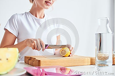 Female hands cutting fruits on a board Stock Photo