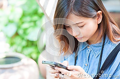 Close-up of female hands using modern smart phone while working,Young woman using a touchscreen smartphone Stock Photo