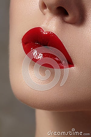 Close-up of female lips with bright makeup. Macro of woman's face. Fashion lip make-up with red gloss Stock Photo