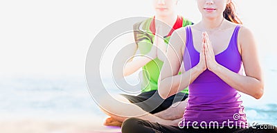 Close up female master yoga doing namaste pose with student at b Stock Photo