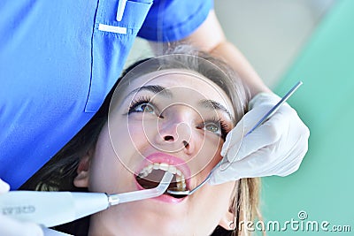 Close-up of female with open mouth during oral checkup at the dentist. Stock Photo