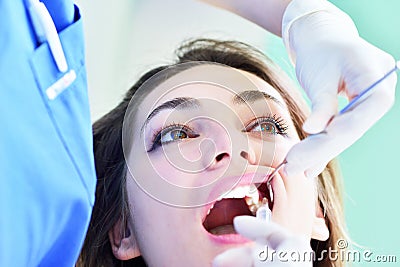 Close-up of female with open mouth during oral checkup at the dentist. Stock Photo