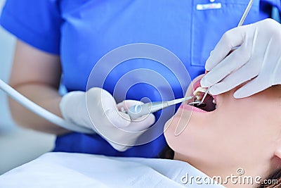 Close-up of female with open mouth during oral checkup at the dentist. Stock Photo