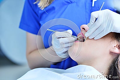 Close-up of female with open mouth during oral checkup at the dentist. Stock Photo