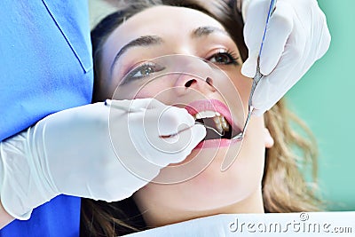 Close-up of female with open mouth during oral checkup at the dentist. Stock Photo