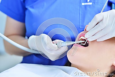 Close-up of female with open mouth during oral checkup at the dentist. Stock Photo