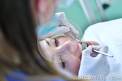 Close-up of female with open mouth during oral checkup at the dentist. Stock Photo