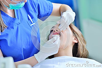 Close-up of female with open mouth during oral checkup at the dentist. Stock Photo