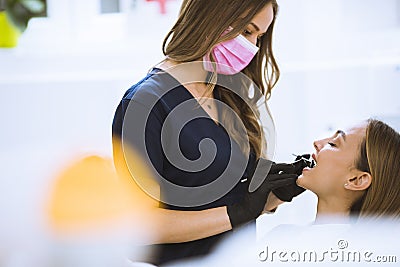 Close-up of female with open mouth during oral checkup at the dentist Stock Photo