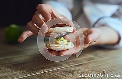 Close up of female pastry chef's hand cooking delicious macaroon Stock Photo