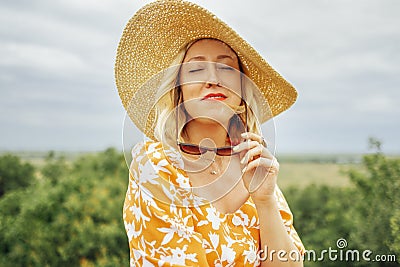 Close up of female portrait of attactive blonde girl closed her eyes and enjoys moment Stock Photo