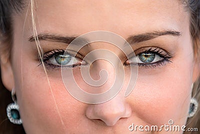 Close up female portrait on intense piercing blue eyes, confident, flirtatious, seductive, sensual stare Stock Photo