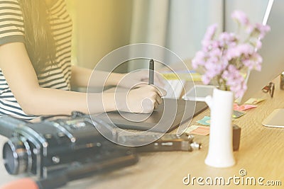 Close-up of female right-hand working on the pen table Stock Photo