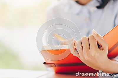 Close-up of female or Secretary hands making notes during discus Stock Photo