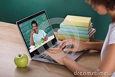 Student Video Conferencing With Teacher On Laptop Stock Photo