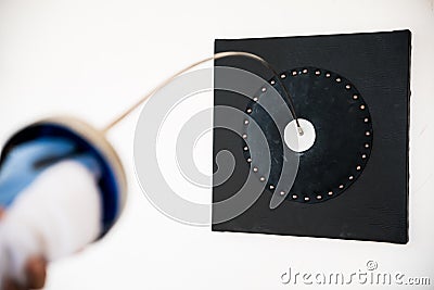 Close up fencing sword hitting the target. Stock Photo