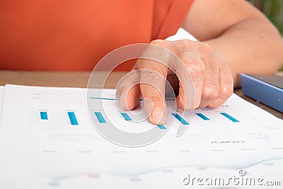 Close up of financial investor finger on financial document Stock Photo