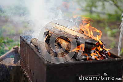 Close up of fire on chargrill. Dry sticks smoulder. Concept of cooking on grill Stock Photo