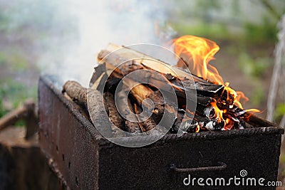 Close up of fire on chargrill. Dry sticks smoulder. Concept of cooking on grill Stock Photo