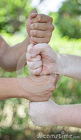 Fists stacked vertically on top of each other Stock Photo