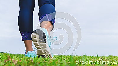 Close up of fitness woman athlete`s running shoes while walking in the park outdoor. Sport, healthy, wellness and active lifestyl Stock Photo