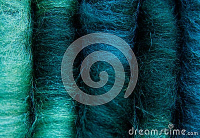 Close-up of five merino wool rolags, in colours green, turquoise, and blue Stock Photo