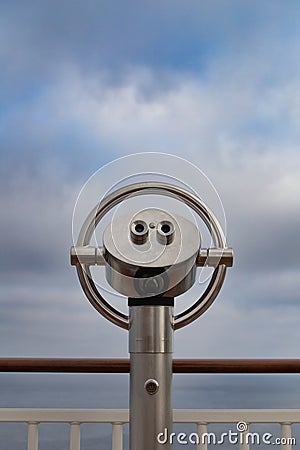 Close up of a fixed telescope at a vantage point against a cloudy sky Stock Photo