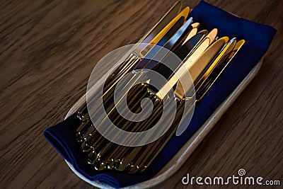 Close up of flatware knives on wooden table Stock Photo