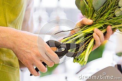 Close up of florist man with flowers and pruner Stock Photo